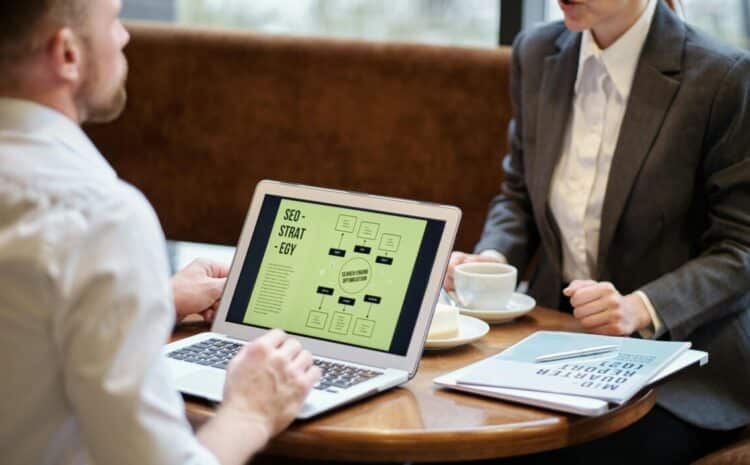 A man and woman engaged in a business meeting discussing SEO strategy in a cozy cafe setting. — Photo by Jack Sparrow on Pexels