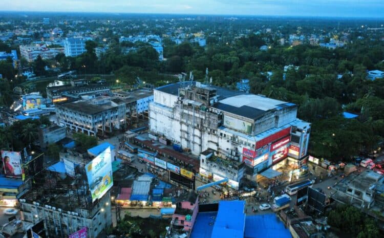 Aerial view of a vibrant urban area with buildings and trees at dusk, showcasing city life. — Photo by Soumil Chakraborty on Pexels