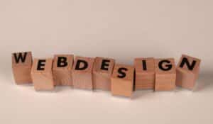 Wooden blocks spelling 'web design' creatively showcase digital design concept. — Photo by Ann H on Pexels