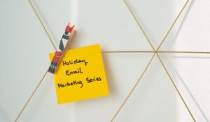 Bright yellow sticky note with holiday email marketing message clipped to a wireframe wall. — Photo by Walls.io on Pexels
