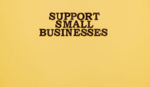 Inspirational image with 'Support Small Businesses' text on a warm yellow background. — Photo by Thirdman on Pexels