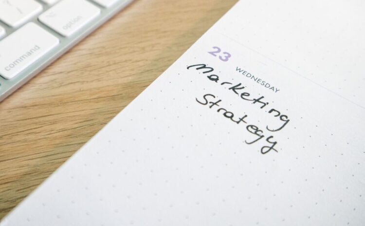 Close-up of a planner with 'Marketing Strategy' handwritten alongside keyboard. — Photo by Walls.io on Pexels