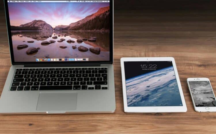 Modern workspace showcasing Apple laptop, tablet, and smartphone on a wooden desk. — Photo by Pixabay on Pexels