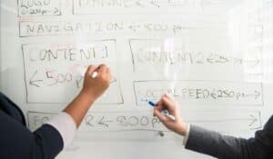 Two people collaboratively planning on a whiteboard with creative strategy. — Photo by Christina Morillo on Pexels
